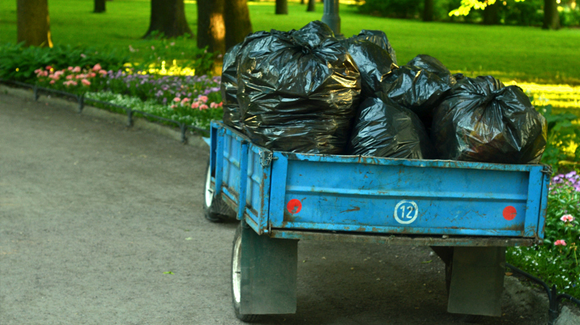 piled-up trash bags on a trailer dumpster