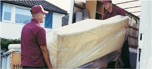 junk removal crew loading furniture onto truck