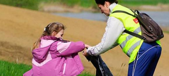 mother and daughter picking up litter