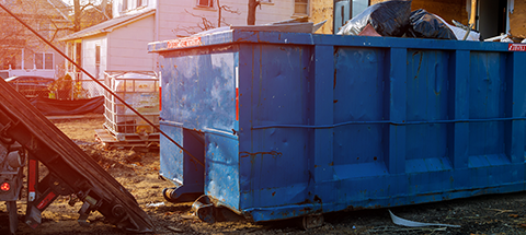 roll-off dumpster sitting in front of home