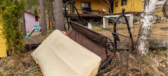 mangled yard furniture upside down in front yard