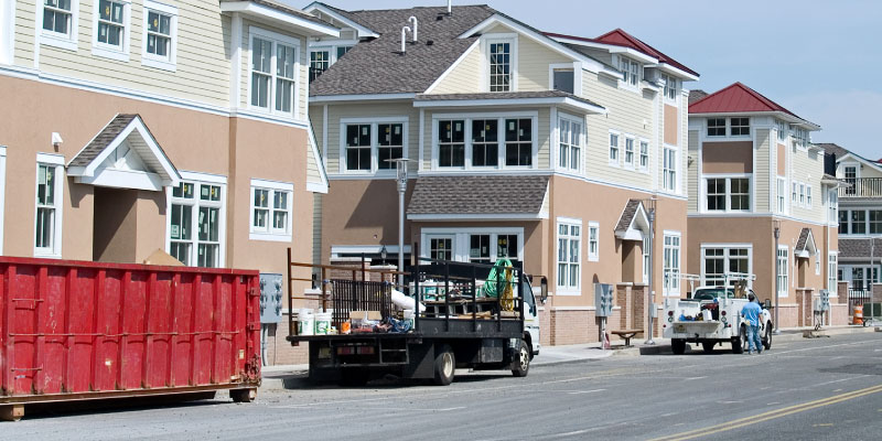 dumpster in front of apartment buildings