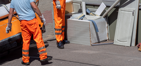 Junk removal crew loading broken furniture