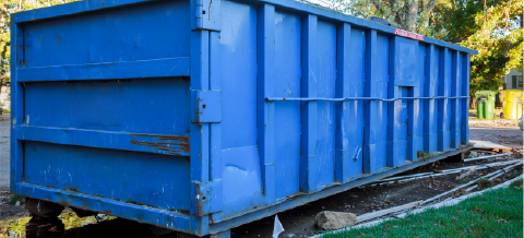 40 yard dumpster sitting on bricks in front yard