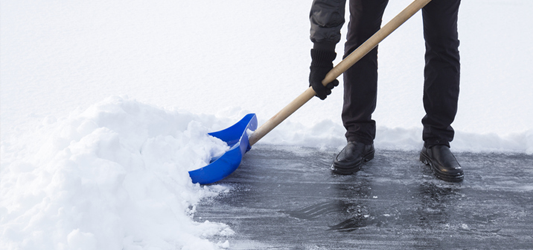 Shoveling snow-covered driveway