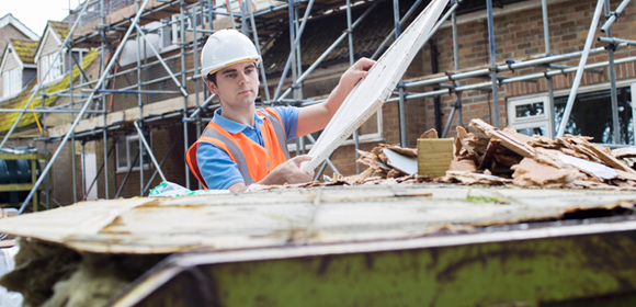 loading a dumpster with construction debris