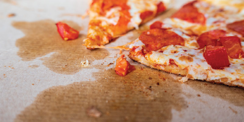 Cardboard pizza box with grease stains