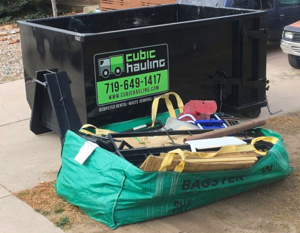 Bag dumpster next to roll-off dumpster