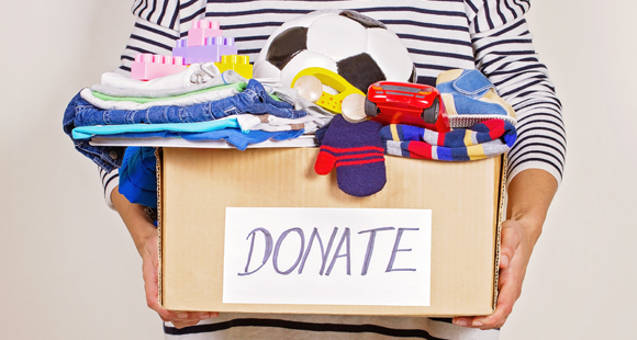 person holding box of items to donate