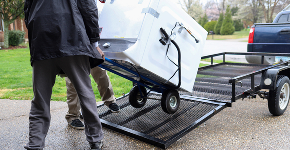 Loading a washer onto a truck trailer