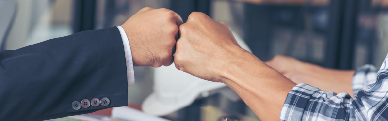 contractor fist bumping marketing team member