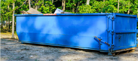 blue dumpster sitting on gravel