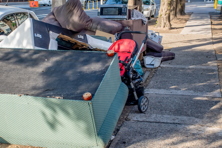 Old furniture, appliances, and other household junk on the curb