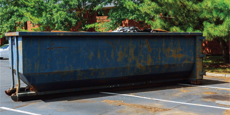 dumpster in parking lot