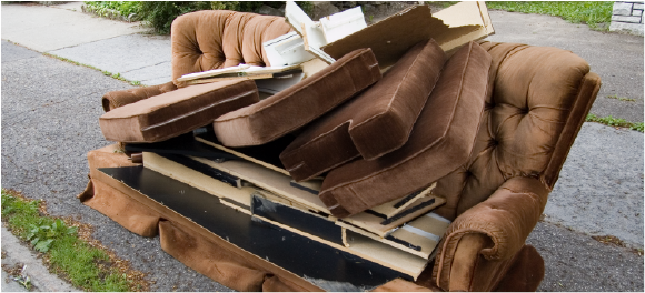 broken couch sitting by the curb for pick-up