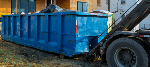 40 yard dumpster being picked up by dumpster truck