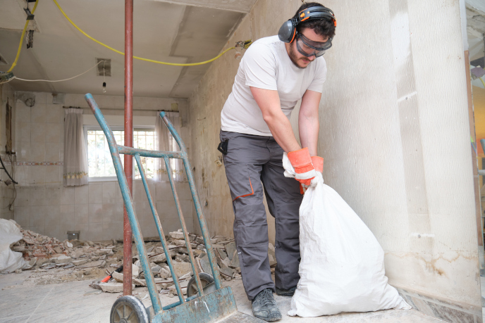 Man cleaning up construction debris