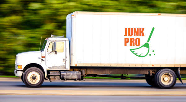 Large junk removal box truck driving down the road