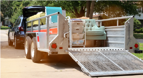 furniture loaded onto trailer connected to vehicle