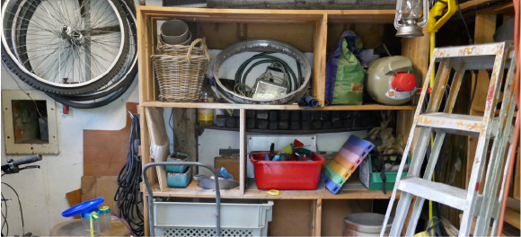 messy garage shelves full of boxes, tools, and junk