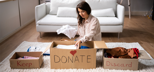 Woman organizing items into separate boxes