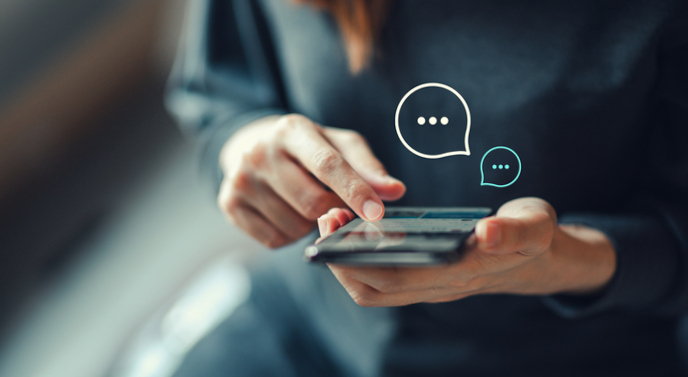 person using smartphone to talk with dumpster company