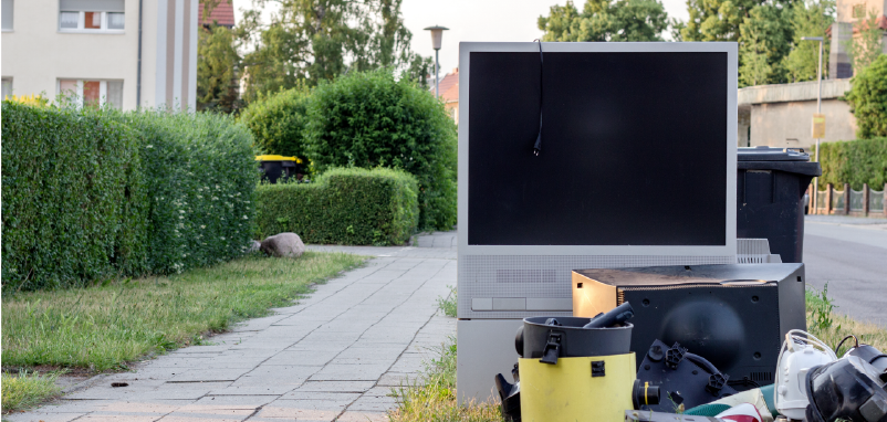 large TV and other electronics placed by the road